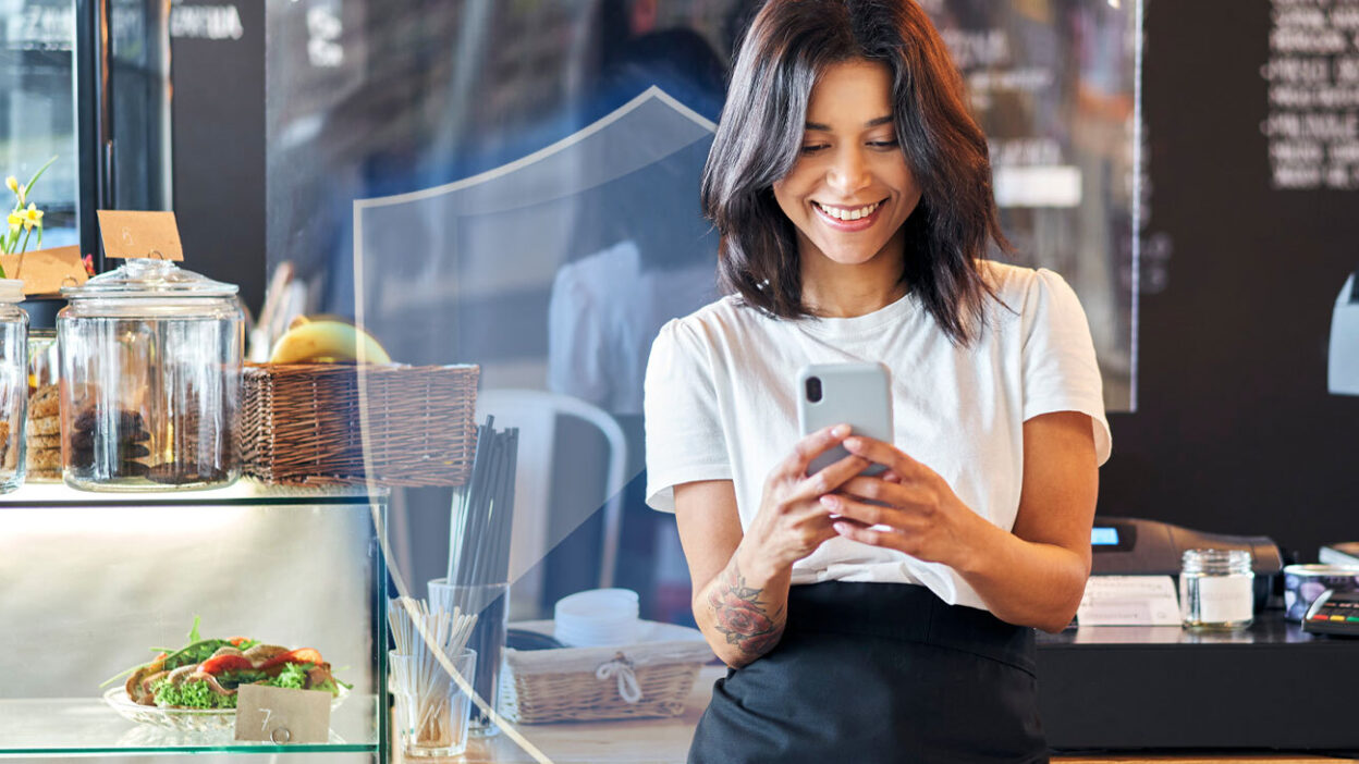 Small business owner, looking at her phone