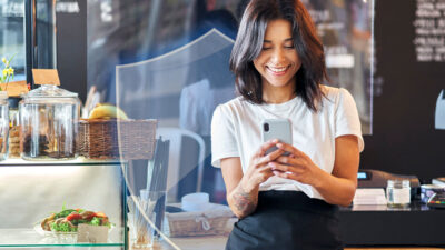 Small business owner, looking at her phone